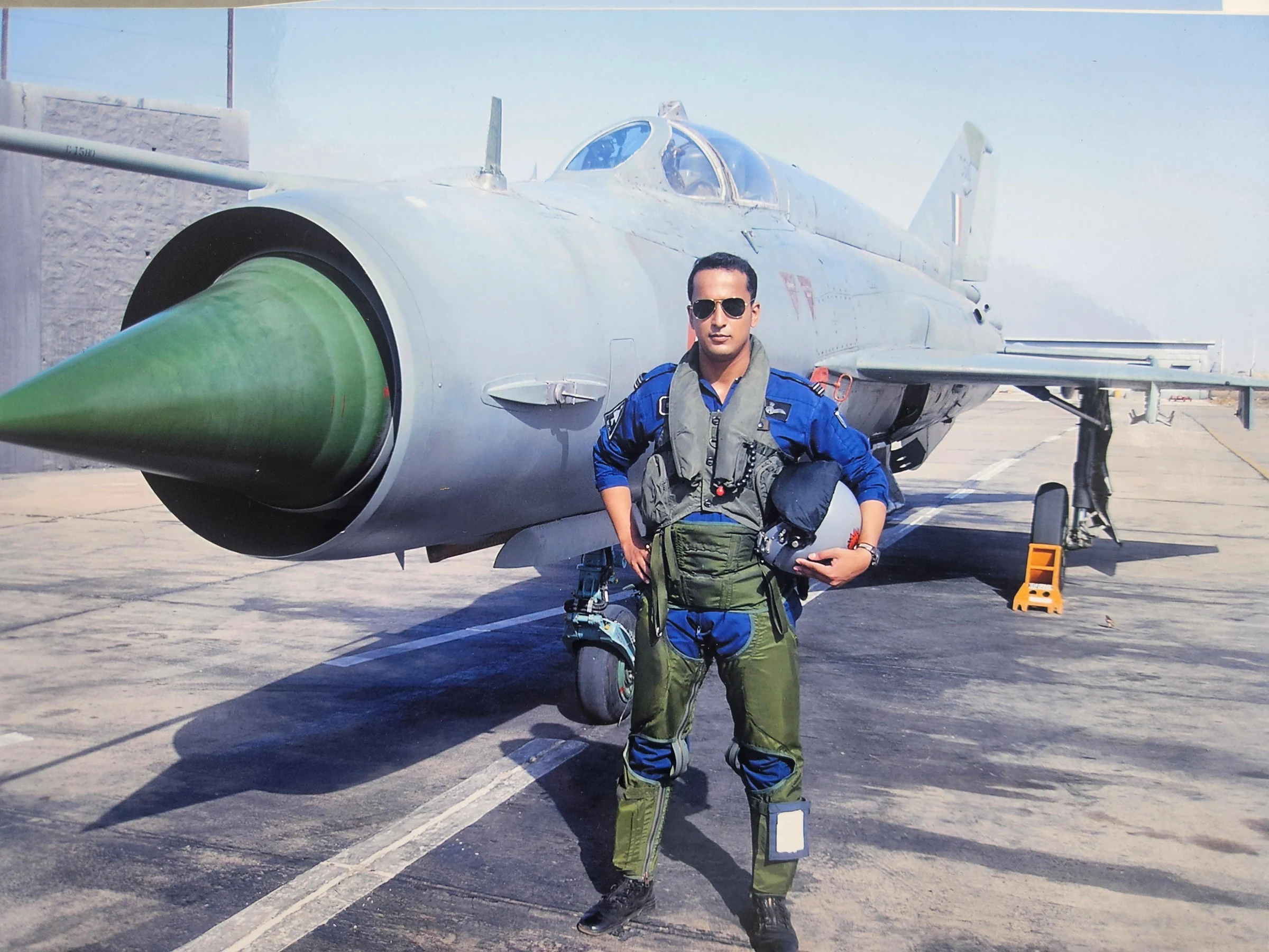 Wg Cdr Amit Sathe in his flight suit standing in front of a fighter aircraft